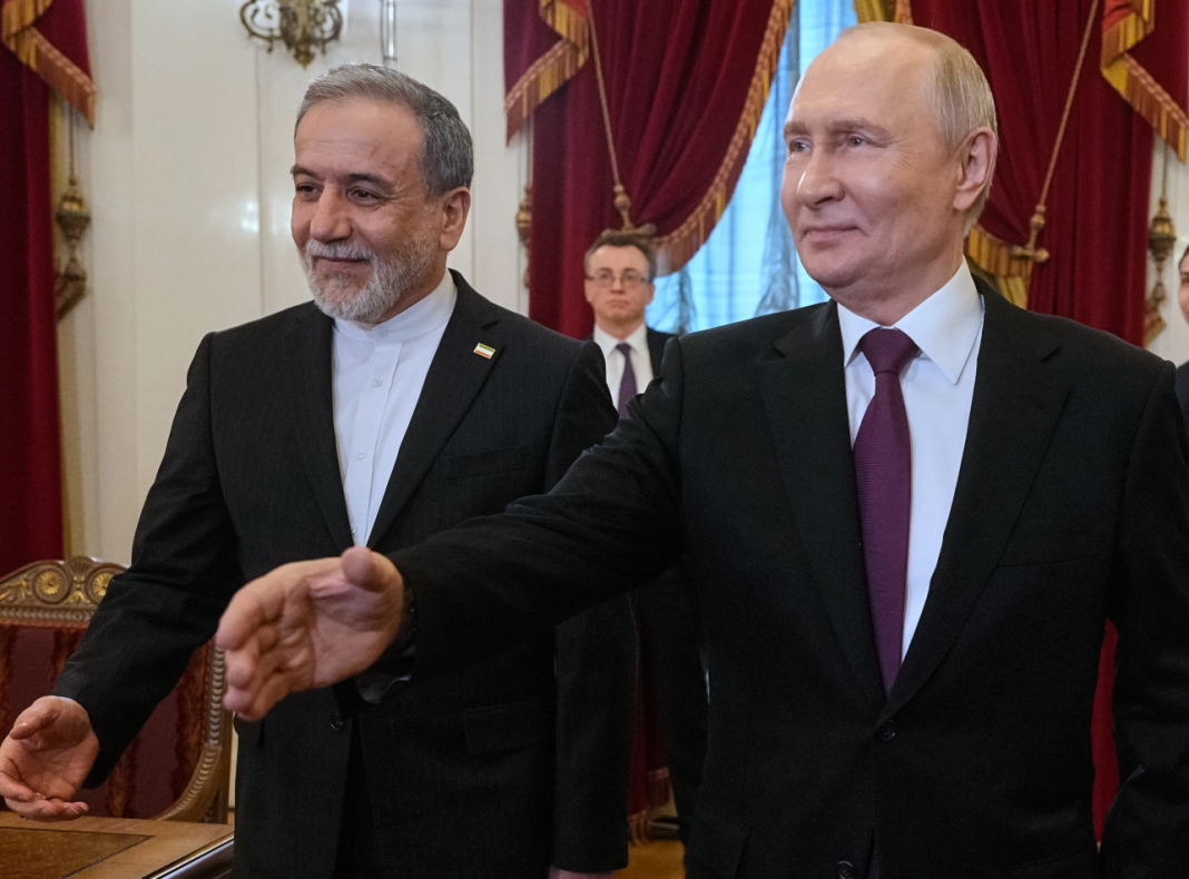 Russian President Vladimir Putin, right, and Iranian Foreign Minister Abbas Araghchi walk to attend the talks at the Boris Yeltsin Presidential Library, in St. Petersburg, Russia, Monday, April 27, 2026. (AP Photo/Dmitri Lovetsky, Pool)